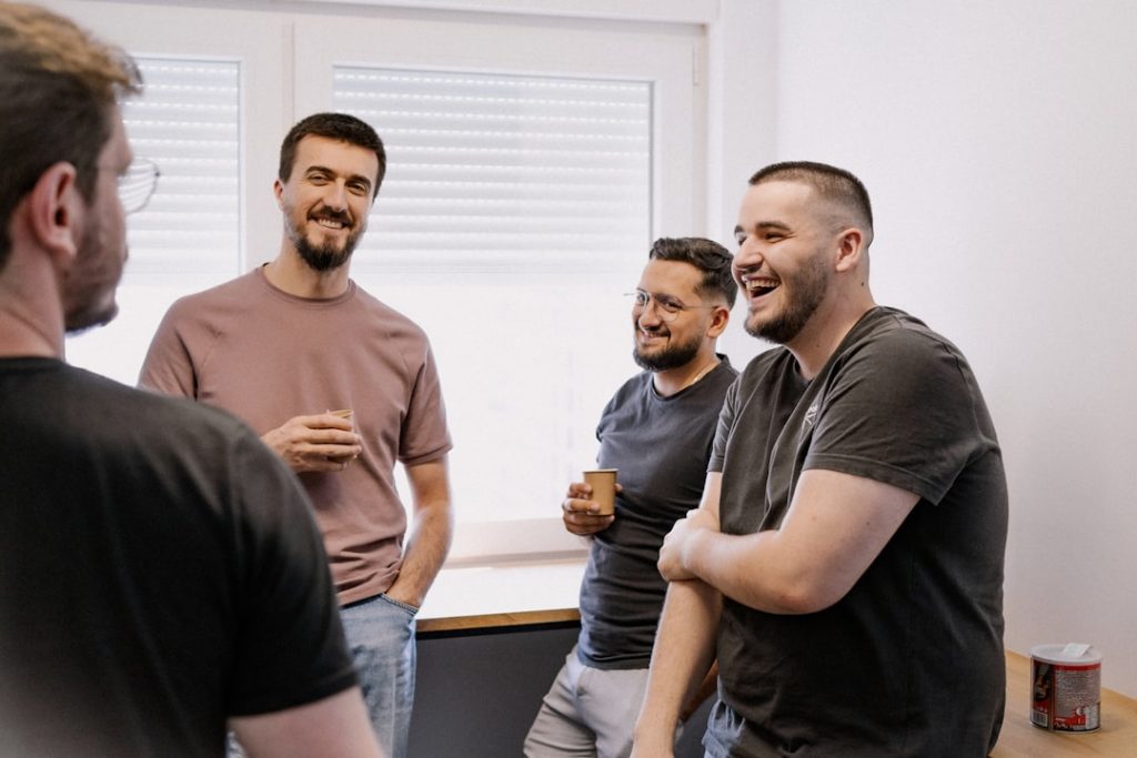 Teamwork Laughing and relaxing with a coffee break at a positive vibe office.